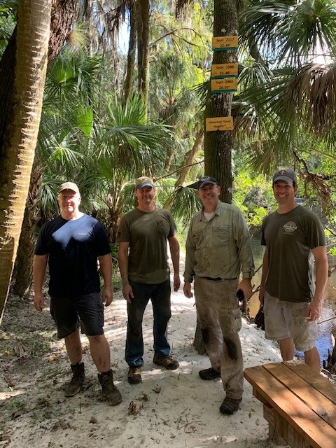 Volunteer crew posing in front of the completed Historical Flood Heights sign
