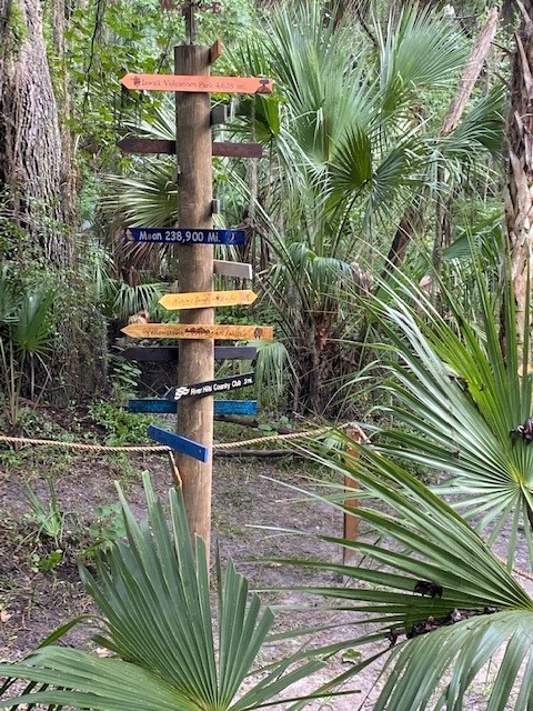 Volunteers raising the landmark pole upright into position
